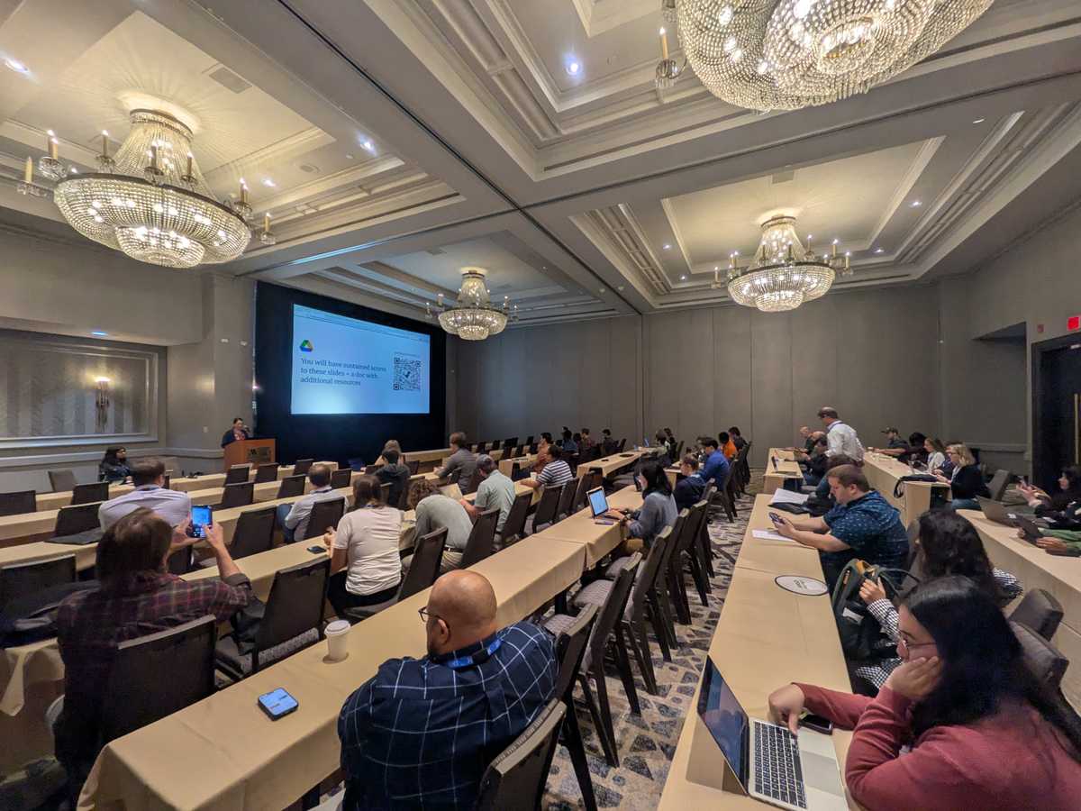 Photo of the room full of workshop participants listening to Mary's presentation